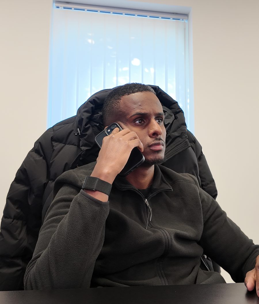 Abdirahman Jama taking a call in the JAMA Logistics office